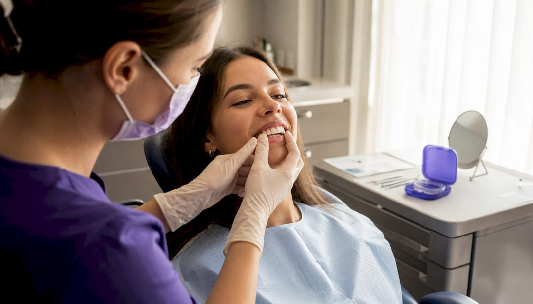 Close-up orthodontist examining teeth after braces