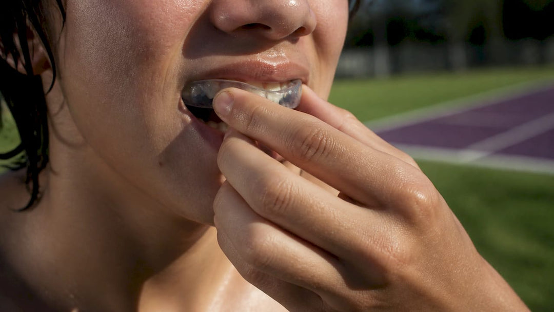 Athlete fitting mouth guard close-up