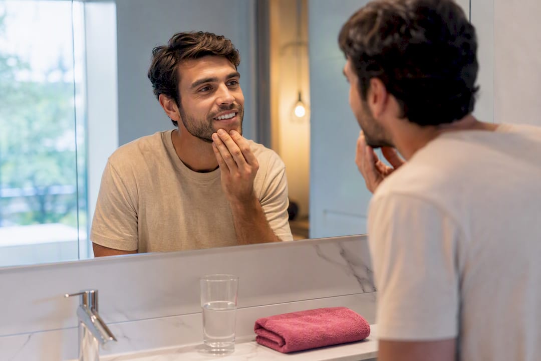 Adult checking smile during home whitening